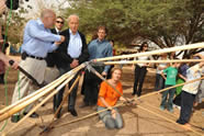 One of the many skills learned on Lotan's creative ecology programs is alternative building. Here, students from the Peace, Justice and the Environment college semester demonstrate to President Shimon Peres how to build a geodesic dome from recycled palm branches.