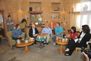 President Shimon Peres gets caught up on the news at Kibbutz Lotan with some of the founding members in the solar powered tea house. He also samples some gourmet cheeses produced from the milk of Lotan's goats.